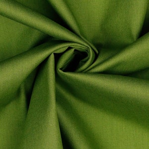 May include: Close-up of a green fabric with a textured weave. The fabric is folded and draped, creating a soft, flowing look.