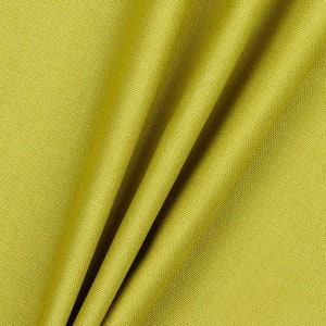 May include: Close-up of a textured, green fabric with a subtle sheen. The fabric is folded in a way that shows the texture and drape.