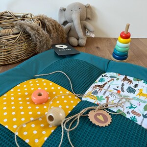 a collection of colorful toys and a stuffed elephant on a wooden surface.