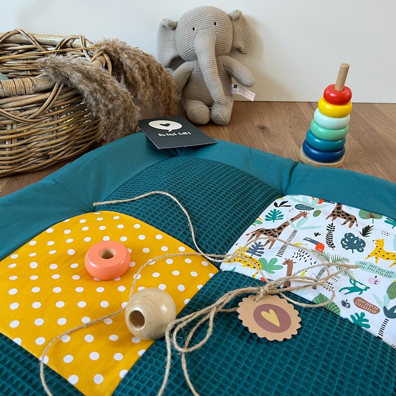 a collection of colorful toys and a stuffed elephant on a wooden surface.