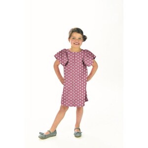 May include: A young girl wearing a pink dress with white stars. The dress has short sleeves with ruffles and a slightly flared skirt. She is wearing gray shoes.