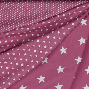 May include: Pink fabric with a white star pattern. The fabric has two different patterns, one with small stars and one with larger stars.
