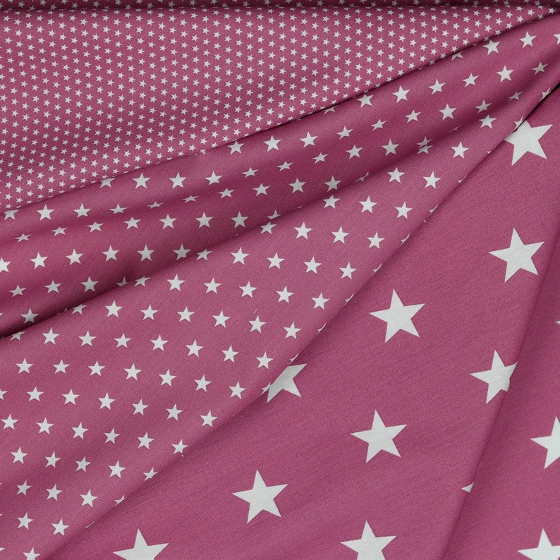 May include: Pink fabric with a white star pattern. The fabric has two different patterns, one with small stars and one with larger stars.