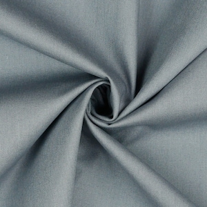 May include: Close-up of a swatch of fabric in a muted teal color. The fabric is tightly woven, with visible texture and folds, creating shadows and highlights. The fabric is gathered in a spiral, with a dark center.