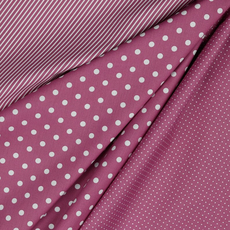 May include: Three fabric swatches in different patterns: pink with white stripes, pink with large white polka dots, and pink with small white polka dots.