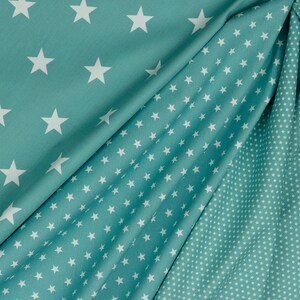 May include: Two pieces of teal fabric with white star patterns. One fabric has large stars and the other has small stars.
