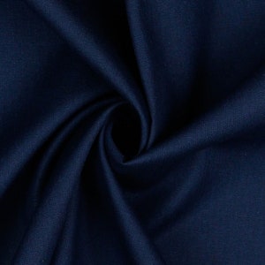 May include: Close-up of a dark blue fabric with a smooth texture. The fabric is folded and draped, creating a soft, flowing look.