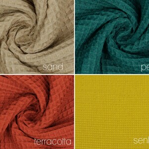 May include: Four fabric swatches in different colors: sand, petrol, terracotta, and senfgelb. Each swatch is a waffle weave fabric.