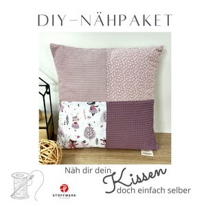 May include: DIY sewing kit for a pink and white patterned pillow with the text "Näh dir dein Kissen doch einfach selber" (Sew your own pillow, just do it yourself).