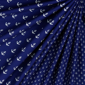 May include: Navy blue fabric with a white anchor pattern. The fabric is folded in a way that shows the pattern from different angles.