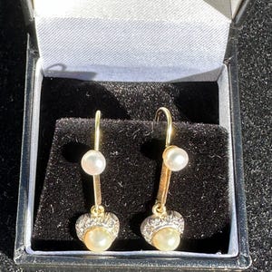 A pretty pair of diamond and pearl  drop earrings in 18 carat gold