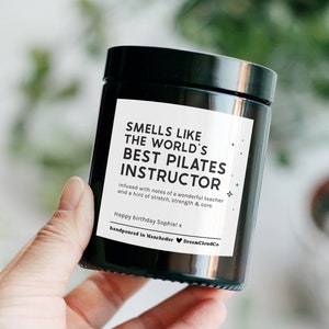 Birthday Gift For Pilates Instructor: Personalised Candle that reads 'smells like the world's best pilates instructor'. Thank you gift for pilates instructor.