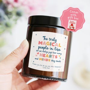May include: A brown glass candle jar with a black lid. The label reads "The truly MAGICAL people in life do not realise just how many HEARTS and MINDS they touch." A pink gift box tag is attached.