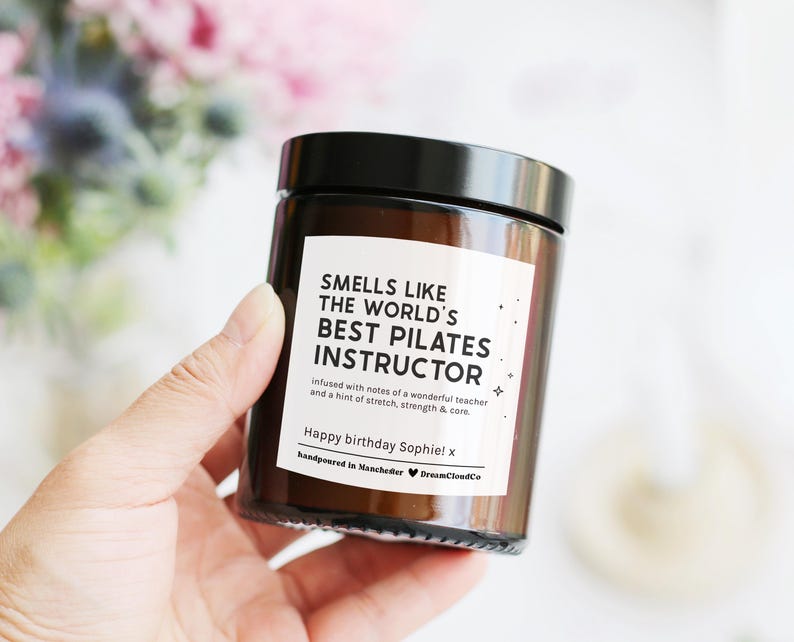 Candle that reads 'smells like the world's best pilates instructor' with customisable message on label. Birthday gift for pilates instructor.