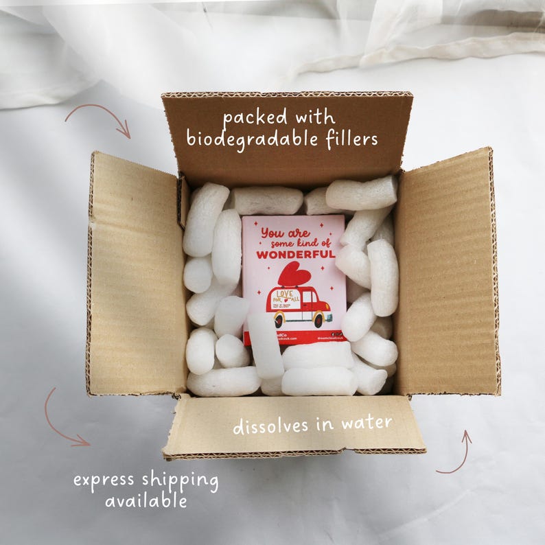 May include: Open cardboard box filled with white packing peanuts and a small card. The card reads "You are some kind of WONDERFUL" with a red car graphic. Text on the box reads "packed with biodegradable fillers" and "dissolves in water".