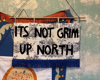 It’s Not Grim Up North wall hanging