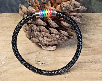 May include: Black leather bracelet with a rainbow colored metal accent. The bracelet is braided and has a magnetic clasp.