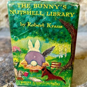 May include: A vintage children's book titled "The Bunny's Nutshell Library" by Robert Kraus. The cover shows a whimsical illustration of a bunny, squirrel, and horse in a forest setting. Published by Harper & Row.