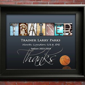 May include: A framed print featuring the word "TRAINER" in a mix of colours and textures. Beneath, it reads "TRAINER LARRY PARKS, North London U18 DS, Season 2023-2024". The word "Thanks" is in cursive, with a basketball at the bottom.