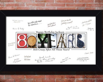 May include: A white framed print with a red and white number 80 and the word "YEARS" spelled out in different images. The text "Happy Birthday Jackson" and "Still Crazy After All These Years!" are printed below the image. The print is covered in handwritten messages.