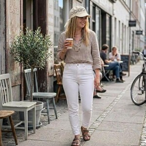 a woman wearing a pastel lace linen bandana hat during a summer walk, showcasing the lightweight and feminine design of this headwear.