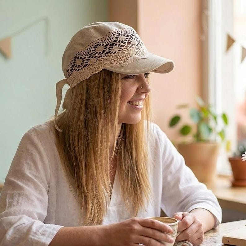 a woman enjoying the sun in a pastel linen headwrap, perfect for a romantic cottagecore look or a day at the seaside.