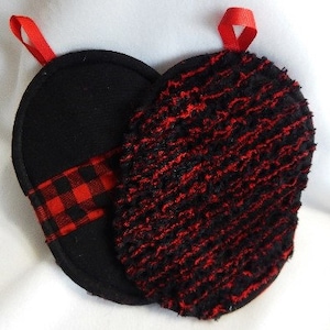 May include: Two black and red pot holders with a red hanging loop. One pot holder is made of a textured fabric and the other is made of a smooth fabric with a red and black checked trim.
