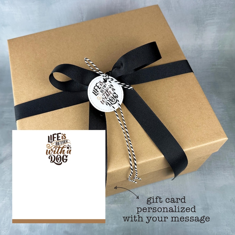 May include: A brown gift box with a black ribbon and a white tag that says "Life is better with a dog". A white gift card with the same text is included. The gift card can be personalized with a message.