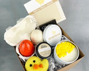 May include: A brown gift box filled with Easter-themed items, including a yellow chick, a bath bomb, a lotion bar, a candle, and a white egg. The box is decorated with shredded paper and a card that reads "Have a Tweet Easter".