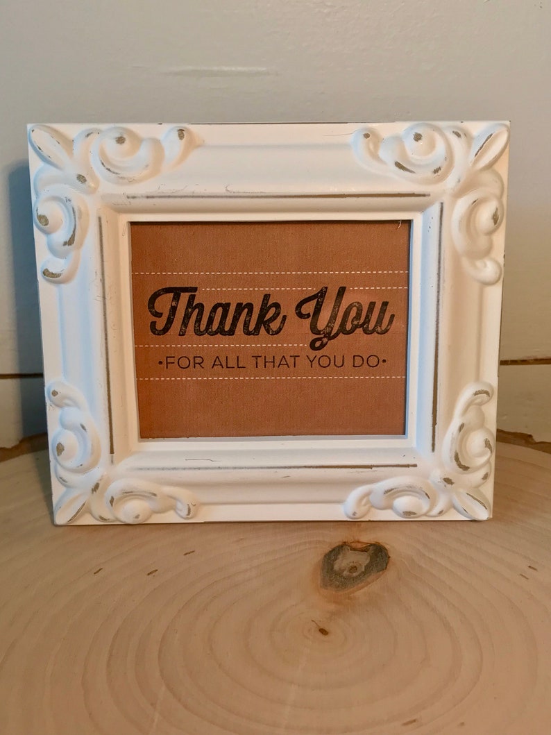 May include: White framed sign with a brown background and the text "Thank You - For All That You Do."