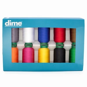 May include: A teal box containing spools of embroidery thread in various colors, including gray, white, blue, red, and brown. The box has the "dime" logo on the top left corner. The spools are arranged in two rows.