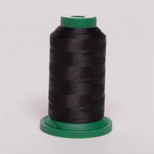 May include: A spool of black thread with a green plastic bobbin.