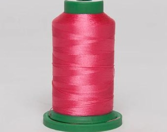 May include: A spool of pink thread with a green plastic bobbin.