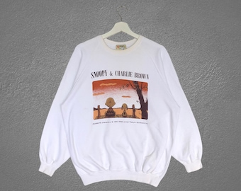 Sudadera vintage rara de Snoopy y Charlie Brown de Cartoon Network con estampado integral y cuello redondo, color blanco.