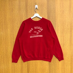 May include: Red sweatshirt with a white graphic of a roadrunner and the text "Van Buren Roadrunners".