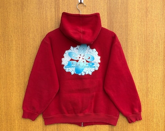 Può includere: Felpa con cappuccio rossa con zip, con un design a fiocco di neve blu e la parola "Puro" al centro.