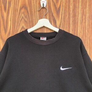 May include: A rustic wooden sign with the text "Welcome to our home" in white lettering. The sign features a distressed finish and a simple, inviting design, perfect for a front porch or entryway.