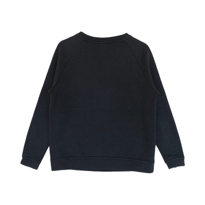 May include: A black long-sleeved sweatshirt with a crew neck and raglan sleeves.