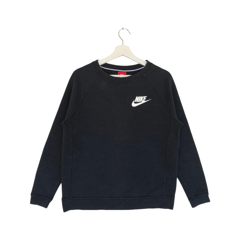 May include: A black sweatshirt with a white Nike logo on the front.