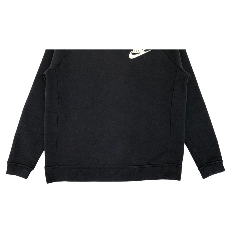 May include: Black sweatshirt with a white Nike logo on the chest.
