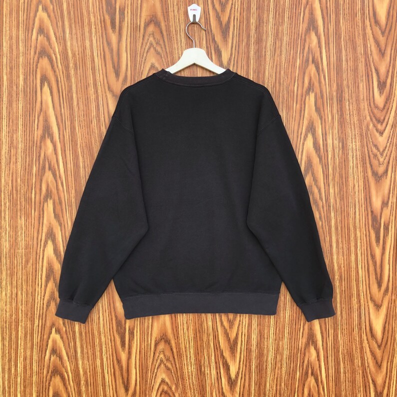 May include: A set of three ceramic mugs with a speckled, matte finish. The mugs are in shades of cream, light gray, and dark gray. Each mug has a simple, minimalist design and a rounded handle.