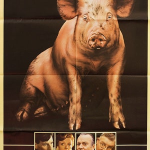 May include: A movie poster for the film "A Private Function" starring Michael Palin, Maggie Smith, and Denholm Elliott. The poster features a large pig in the center, with the title of the film in large, stylized letters at the top. The poster also includes the names of the actors and the film's director, Malcolm Mowbray.