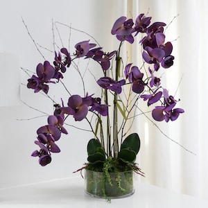 Purple orchids in a glass dish