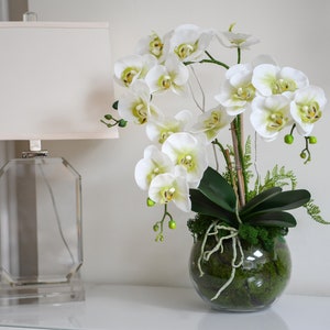 Artificial orchids in a glass bowl. Real touch orchid arrangement.