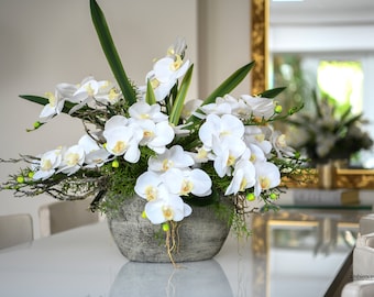Dining table orchid arrangement - White silk  artificial orchid in a concrete boat shaped  vase with leaves
