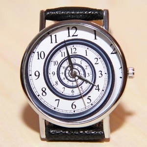 May include: A silver wristwatch with a black leather band. The watch face has a white background with black numbers and a spiral design.