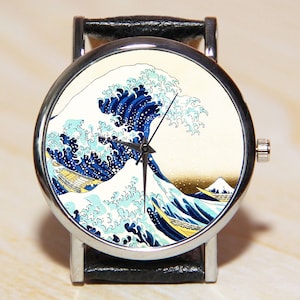 May include: A silver wristwatch with a black leather band features a colorful print of "The Great Wave off Kanagawa" by Katsushika Hokusai.