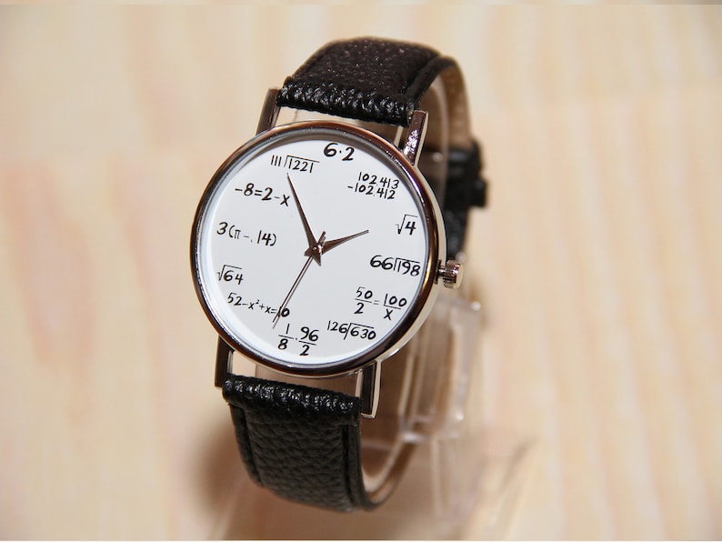 May include: A white wristwatch with a black leather band. The watch face features various mathematical equations, including 6.2, 1221, -8-2-x, 3(&pi;-.14), &radic;64, 52-x&sup2;+x=0, 196/82, 102413/-102.412, &radic;4, 66/198, 50-100/2 X, and 126/630.