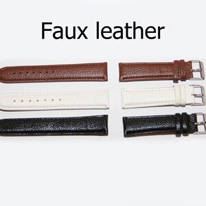 May include: Three faux leather watch straps in brown, white, and black. Each strap has a silver buckle.