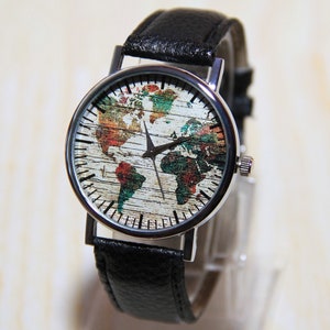 May include: A silver watch with a black leather band. The watch face features a colorful world map design.